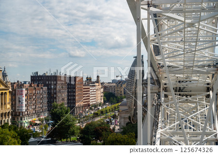 Ferris Wheel In Hungary Budapest. Erzsebet Square, St. Stephen's Basilica, Andrassy Street. Budapest Eye. High quality photo 125674326