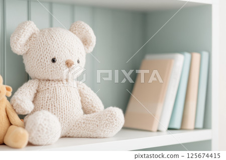 Cozy knitted plush bear sitting on shelf in nursery with books adding soft and serene atmosphere, AI Generative 125674415