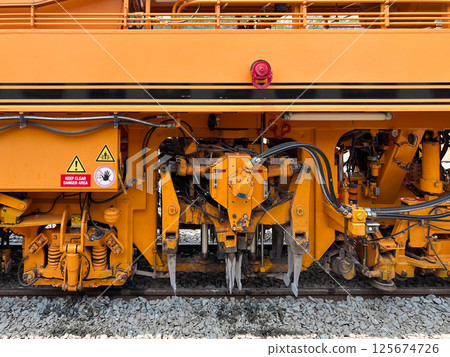 Ballast tamper machine at Railway Station. 125674726