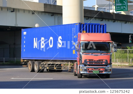 A trailer truck turning right at an intersection 125675242