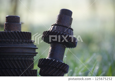Rusty gears and shafts creating an interesting outdoor sculpture 125675252