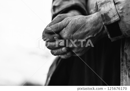 These hands have worked the land for decades. His old hands hold the weight of experience. These hands have worked the land for decades. His old hands hold the weight of experience. 125676170