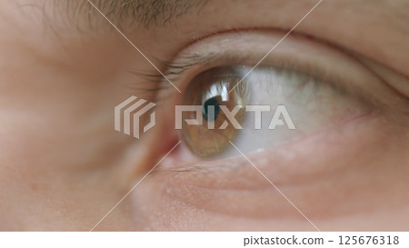 A closeup of a human eye in natural light, revealing intricate details and vibrant colors A closeup of a human eye in natural light, revealing intricate details and vibrant colors 125676318