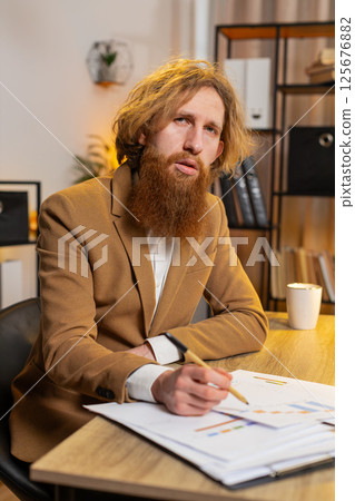 POV of businessman explaining showing report charts and graphs at home office table video call 125676882