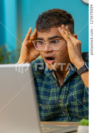 Frustrated business man having software problems with laptop error or mistake virus notification 125676894