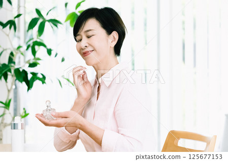 Senior woman enjoying the scent 125677153