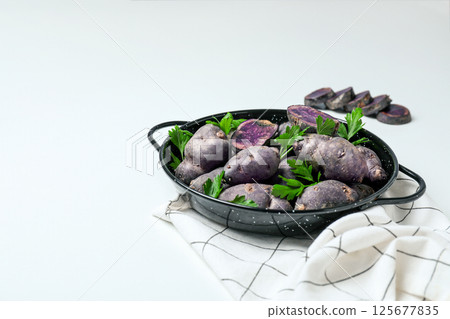 Concept of unusual vegetable - purple potato vegetable 125677835