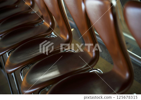 Chairs lined up against the wall Chairs lined up against the wall 125678315