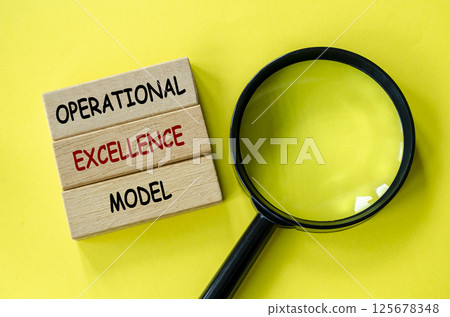 Operational Excellence Model text on wooden blocks with magnifying glass as background. Root cause analysis concept 125678348