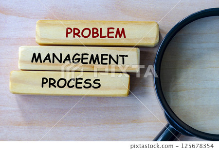 Top view of Problem Management Process text on wooden blocks with magnifying glass as background. Root cause analysis concept Top view of Problem Management Process text on wooden blocks with magnifying glass as background. Root cause analysis concept 125678354