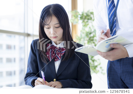 High school students studying at a cram school and their instructor 125678541
