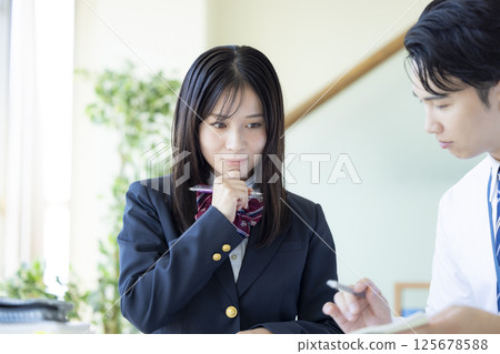 High school students studying at a cram school and their instructor High school students studying at a cram school and their instructor 125678588