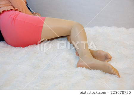 Beautiful legs of a woman wearing shiny pantyhose 125678730