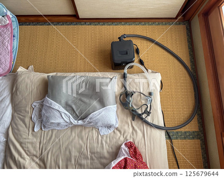 Futon and CPAP in the Japanese-style room at my parents' house 125679644