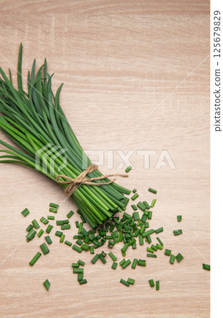 Freshly cut chives tied with twine on wooden table Freshly cut chives tied with twine on wooden table 125679829