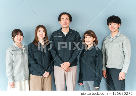 Employees and staff (businessmen and businesswomen) wearing work clothes working at small and medium-sized enterprises such as factories and construction companies. Employees and staff (businessmen and businesswomen) wearing work clothes working at small and medium-sized enterprises such as factories and construction companies. 125680275