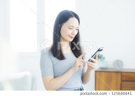 A woman watching a smartphone 125680841