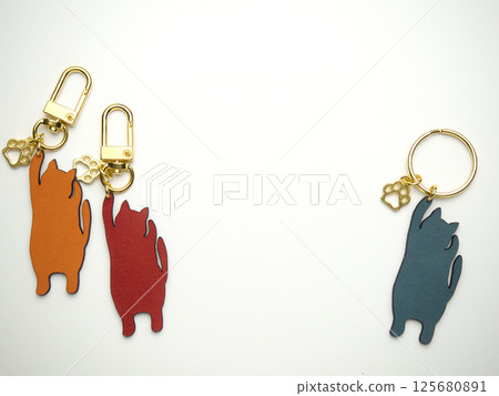 Colorful handmade cat keychain with raised paws 125680891