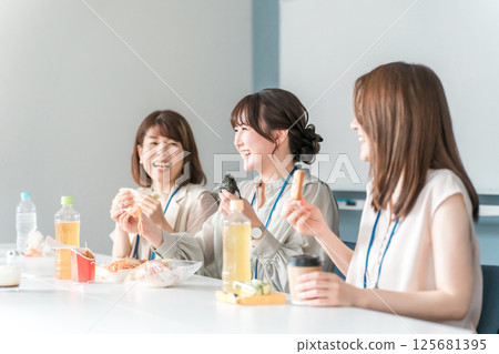 Businesswoman having lunch in company cafeteria/break room 125681395