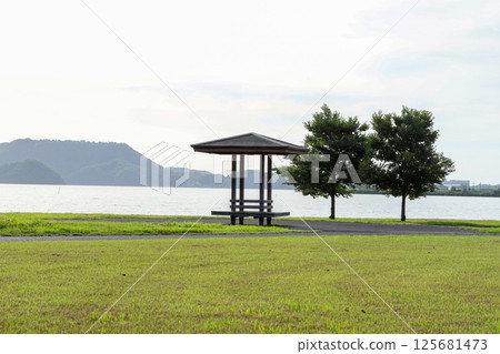 A gazebo standing majestically on the shores of Lake Koyama at dusk A gazebo standing majestically on the shores of Lake Koyama at dusk 125681473