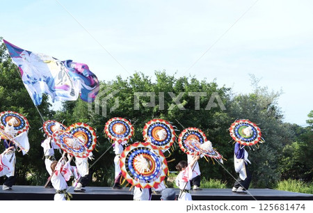 A vibrant umbrella dance on the stage at the event A vibrant umbrella dance on the stage at the event 125681474