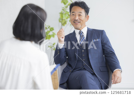 Businessman being interviewed 125681718