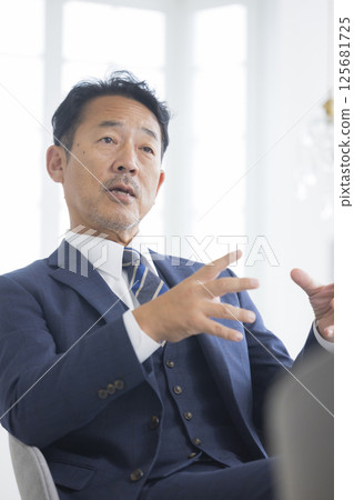 Businessman being interviewed 125681725