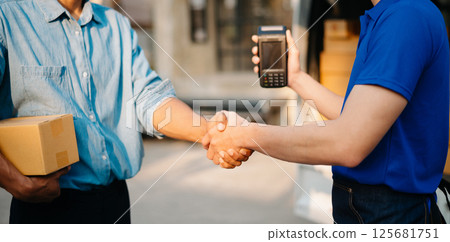 Delivery man by sending box of parcel to customers service at home as having corona virus disease and shipping concept. Delivery man by sending box of parcel to customers service at home as having corona virus disease and shipping concept. 125681751