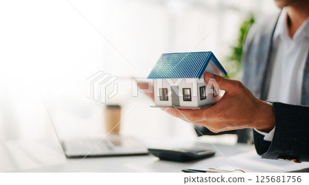 Considering buying a home, investing in real estate. Broker signs a sales agreement. agent, lease agreement, successful deal Considering buying a home, investing in real estate. Broker signs a sales agreement. agent, lease agreement, successful deal 125681756