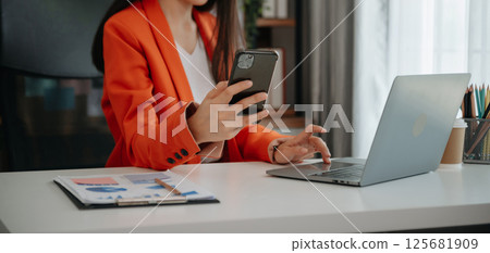 Asian young businesswoman working in the office with working notepad, tablet and laptop documents 125681909