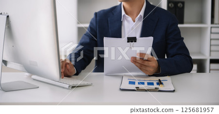 Business man working at office with laptop and documents on his desk new start up project. Finance task. 125681957