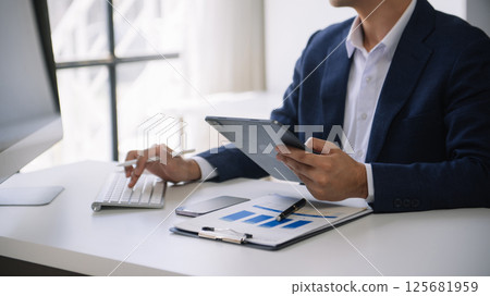 Business man working at office with laptop and documents on his desk new start up project. Finance task. 125681959