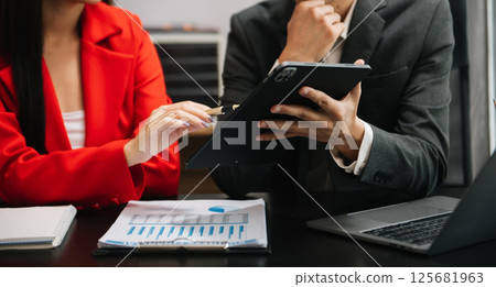 Team work process. Photo young business crew working with new startup project. Project managers meeting. Analyze plans, papers. At office Team work process. Photo young business crew working with new startup project. Project managers meeting. Analyze plans, papers. At office 125681963
