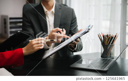 Team work process. Photo young business crew working with new startup project. Project managers meeting. Analyze plans, papers. At office 125681965