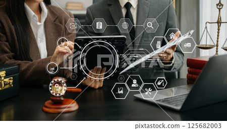 justice and law concept. asian woman lawyer working and judge in a courtroom the gavel, working with tablet and laptop on table 125682003