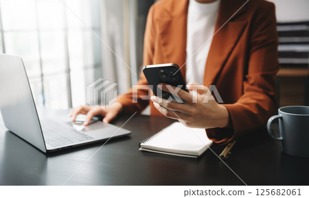 Businesswomen analyzing investment graph and discussing plan new start up project. Finance task. Businesswomen analyzing investment graph and discussing plan new start up project. Finance task. 125682061