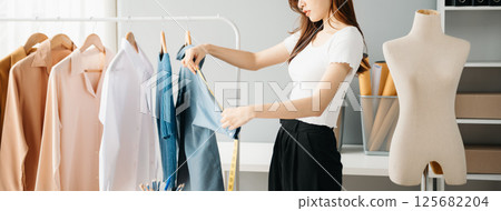 Young woman running online store Startup small business SME, using smartphone or tablet receive and checking online purchase shopping order Young woman running online store Startup small business SME, using smartphone or tablet receive and checking online purchase shopping order 125682204