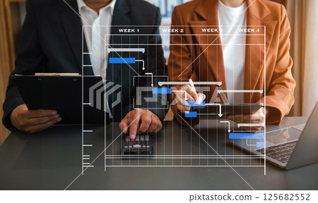 Project manager working and update tasks with milestones progress planning and Gantt chart scheduling diagram. business working with smart phone, tablet and laptop Project manager working and update tasks with milestones progress planning and Gantt chart scheduling diagram. business working with smart phone, tablet and laptop 125682552