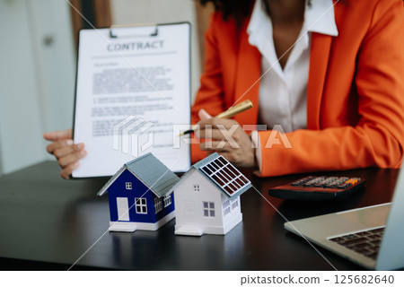 Considering buying a home, investing in real estate. Broker signs a sales agreement. agent, lease agreement, successful deal Considering buying a home, investing in real estate. Broker signs a sales agreement. agent, lease agreement, successful deal 125682640