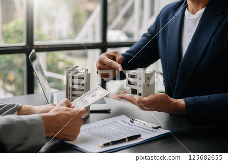 Salesman Hands On House Model , Small Toy House Small Mortgage Property insurance and concepts real estate Salesman Hands On House Model , Small Toy House Small Mortgage Property insurance and concepts real estate 125682655
