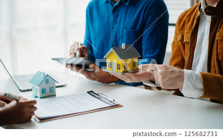 Considering buying a home, investing in real estate. Broker signs a sales agreement. agent, lease agreement, successful deal 125682731