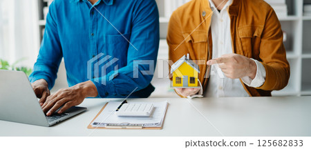 Sales giving male customer signing sales contract, Asian woman and man doing business in office, business concept and contract signing. 125682833