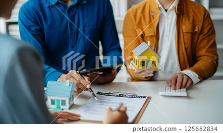 Considering buying a home, investing in real estate. Broker signs a sales agreement. agent, lease agreement, successful deal Considering buying a home, investing in real estate. Broker signs a sales agreement. agent, lease agreement, successful deal 125682834
