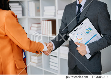 Two confident business man shaking hands during a meeting in the office, success, dealing, greeting and partner Two confident business man shaking hands during a meeting in the office, success, dealing, greeting and partner 125683095