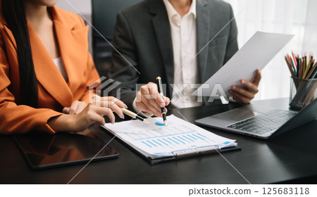 Businessman and team analyzing financial statement Finance task. with smart phone and laptop and tablet. Wealth management concept Businessman and team analyzing financial statement Finance task. with smart phone and laptop and tablet. Wealth management concept 125683118