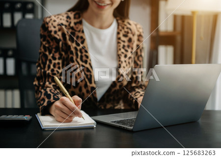Businesswoman hand using laptop, tablet and smartphone in office. Digital marketing media mobile app and discussing plan new start up project. Businesswoman hand using laptop, tablet and smartphone in office. Digital marketing media mobile app and discussing plan new start up project. 125683263