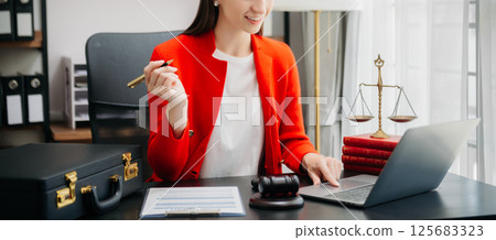 justice and law concept.Female judge in a courtroom on wooden table and Counselor or Female lawyer working in office. justice and law concept.Female judge in a courtroom on wooden table and Counselor or Female lawyer working in office. 125683323