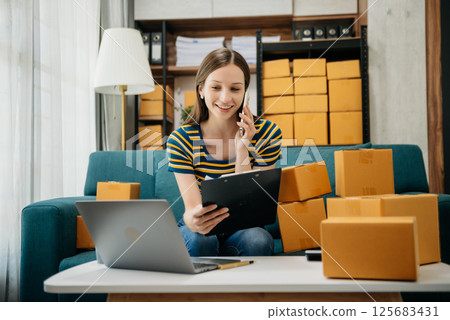 Small business entrepreneur SME freelance woman working at home office, BOX,tablet and laptop online, marketing, packaging, delivery Small business entrepreneur SME freelance woman working at home office, BOX,tablet and laptop online, marketing, packaging, delivery 125683431