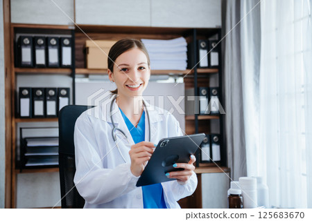 America smiling doctor or consultant sitting at a desk his neck looking at the camera 125683670