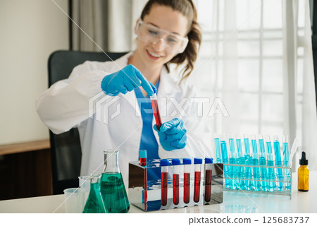 Modern medical research laboratory. female scientist working with micro pipettes analyzing biochemical samples, advanced science chemical laboratory for medicine. 125683737